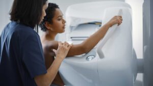 young black woman receiving a mammogram from a female physician